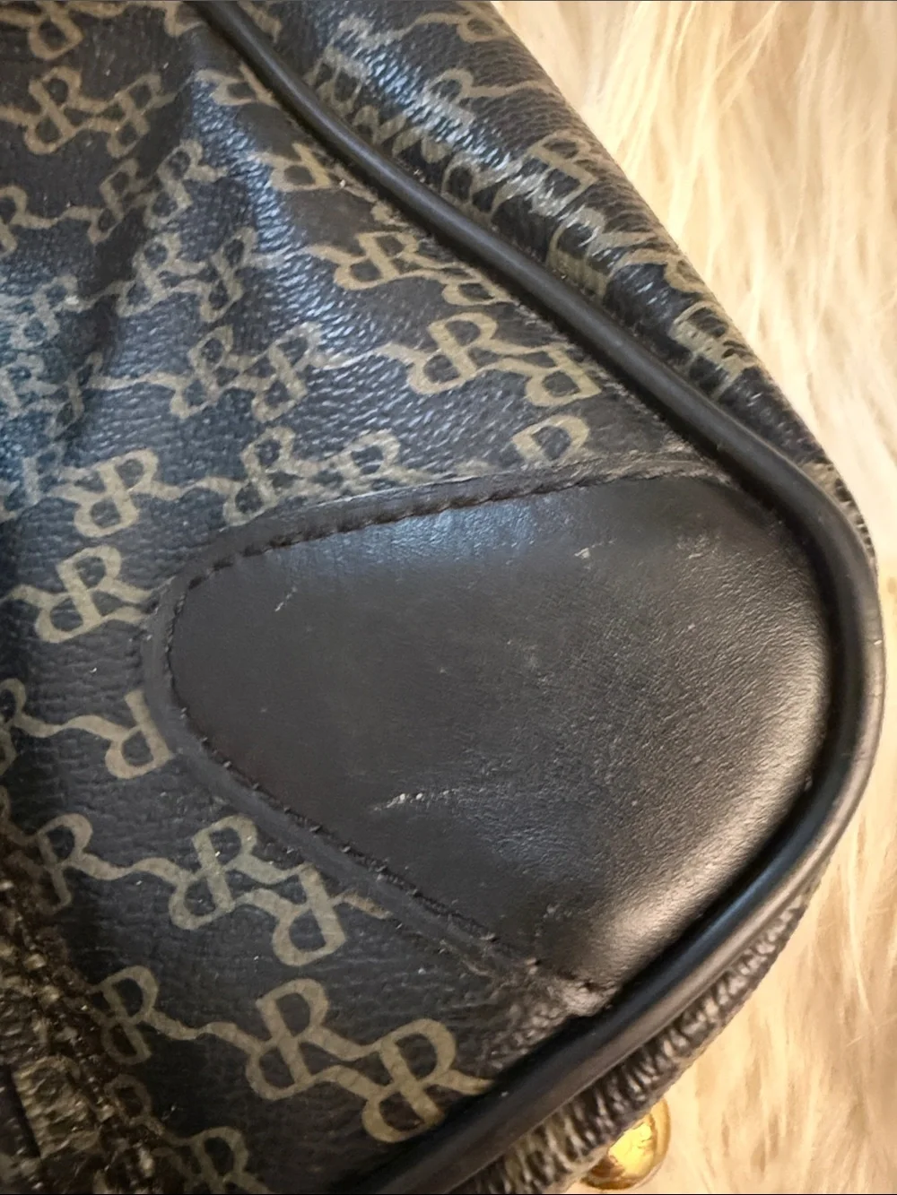 Rioni Signature Organizer Satchel featuring a black monogram 